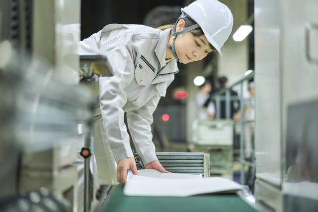 刷機紙送りしている女性